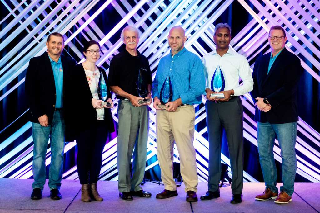 Community Award winners pose with their awards on stage