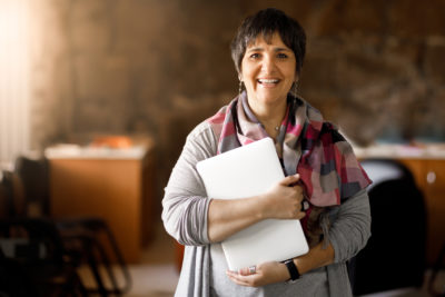 Adult student holding laptop